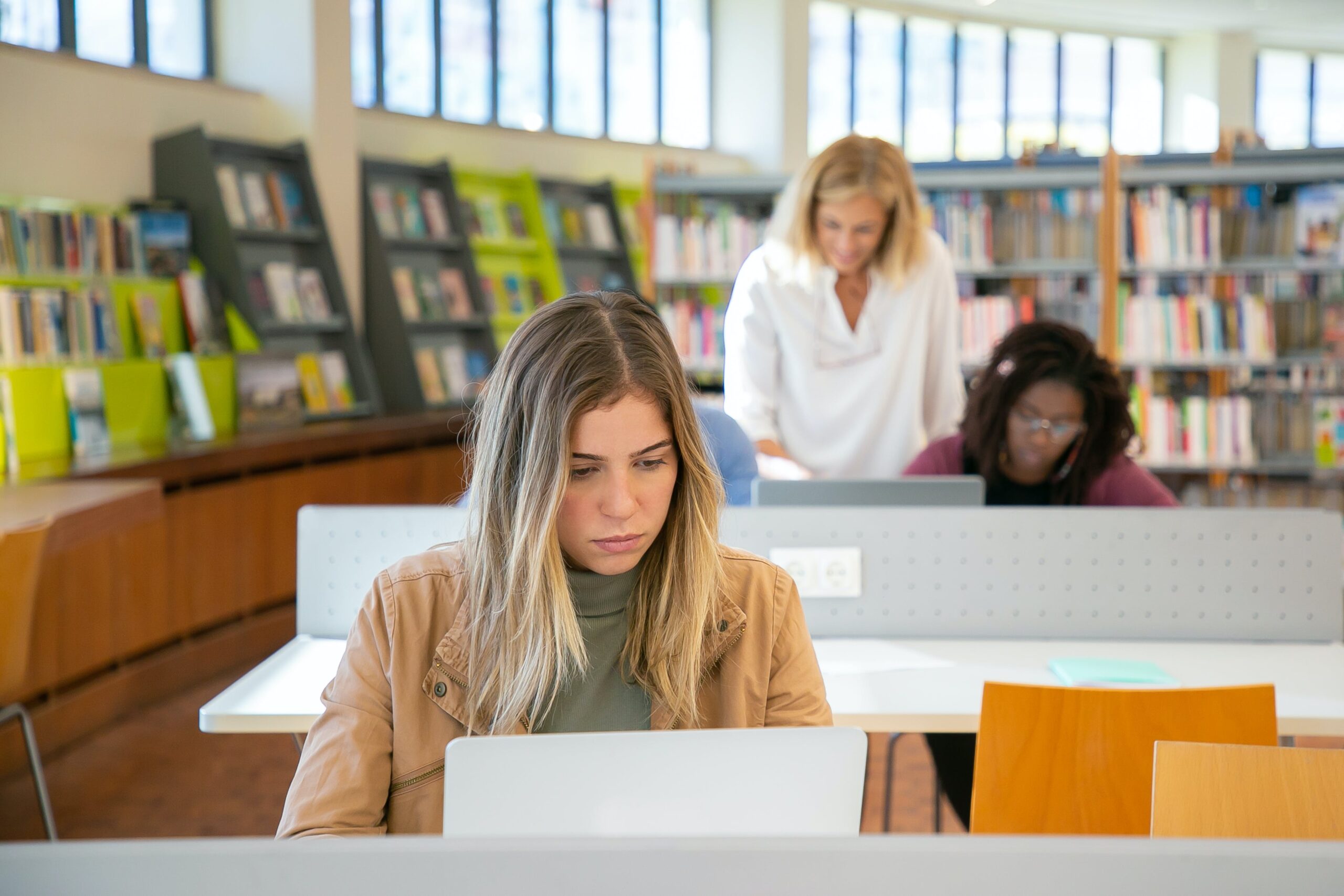 Woman using a laptop in an online class environment